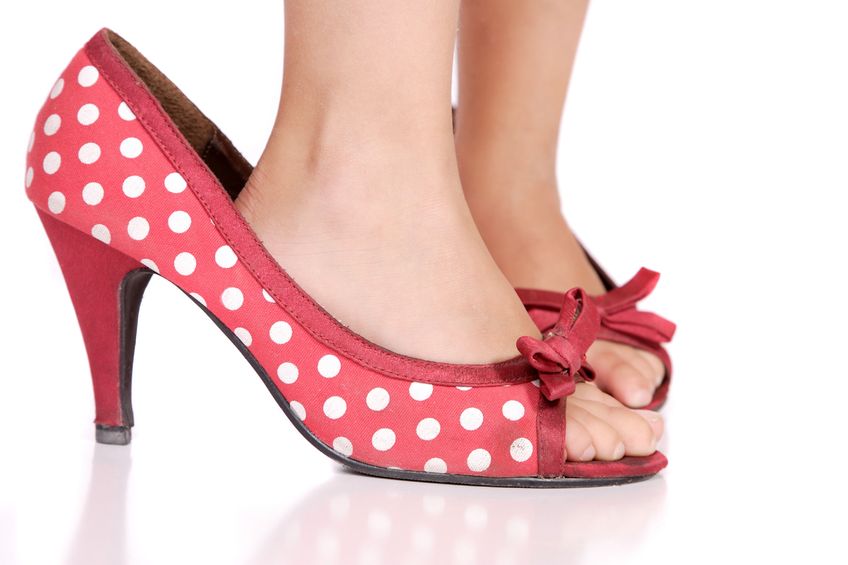 child wearing mothers shoes